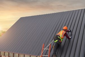 Construction worker maintaining a metal roof